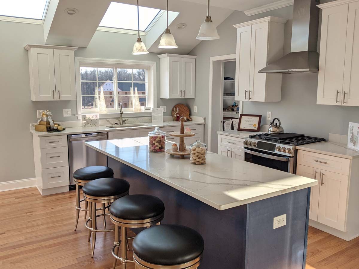 A kitchen with a large island and stools