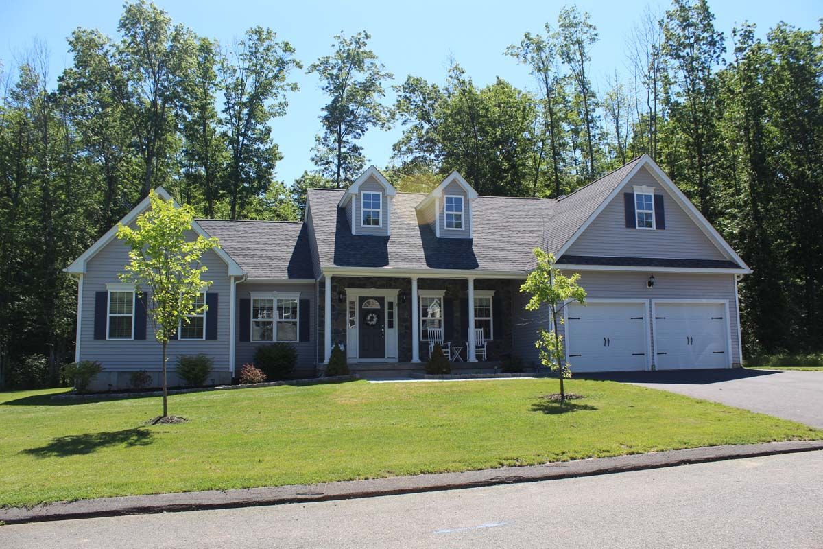 A house with a blue roof and a white garage