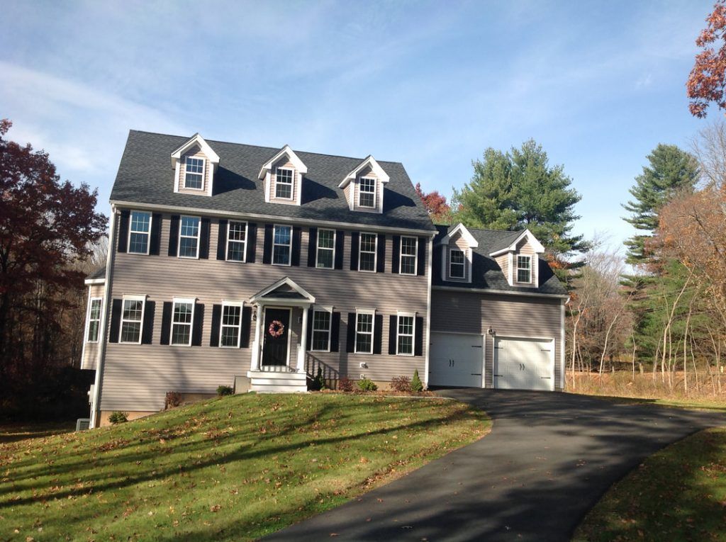 A large house with a driveway leading to it