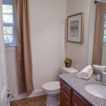 A bathroom with a toilet , sink , and shower.