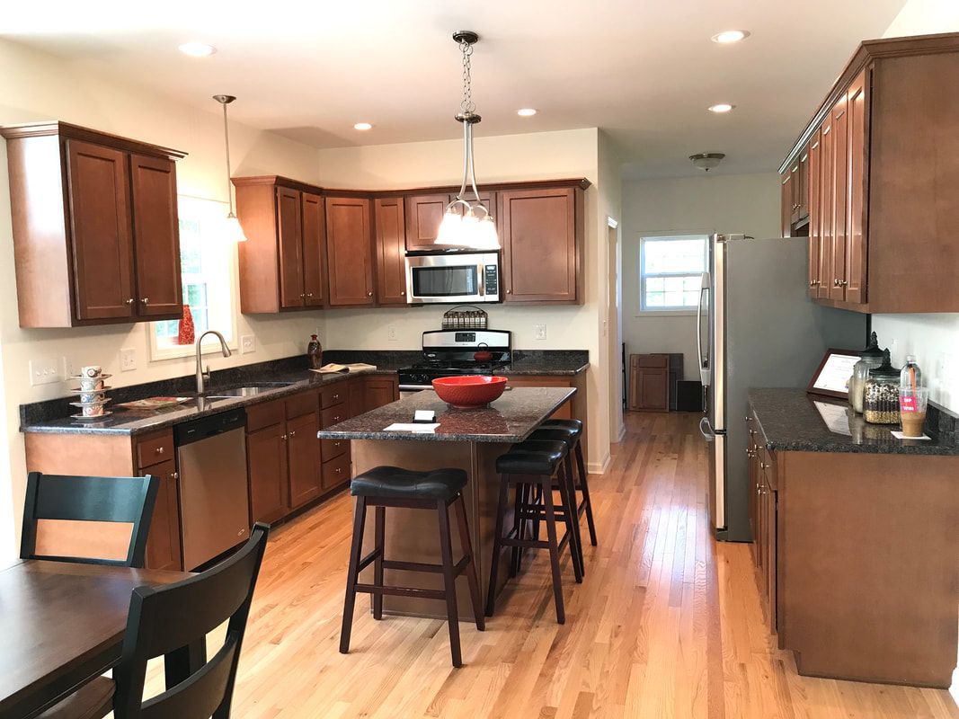 A kitchen with wooden cabinets and stainless steel appliances