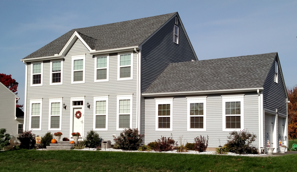 A large white house with a gray roof