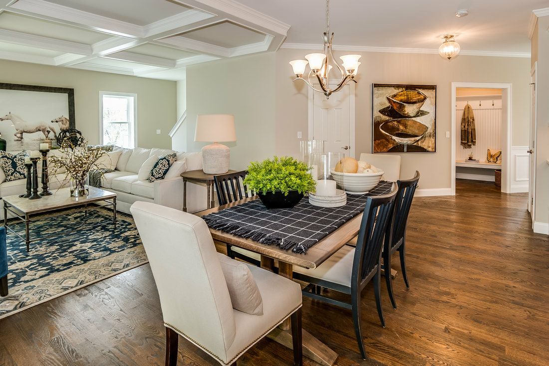 There is a dining table and chairs in the middle of the room.