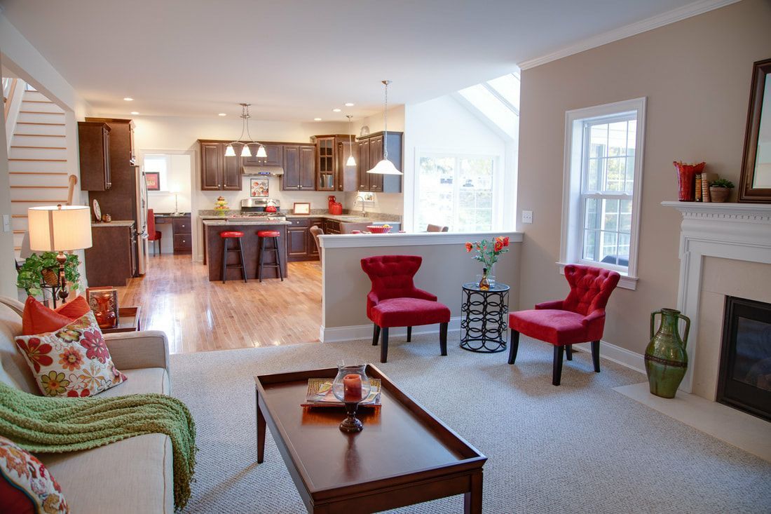 A living room with a couch , chairs , coffee table and fireplace.