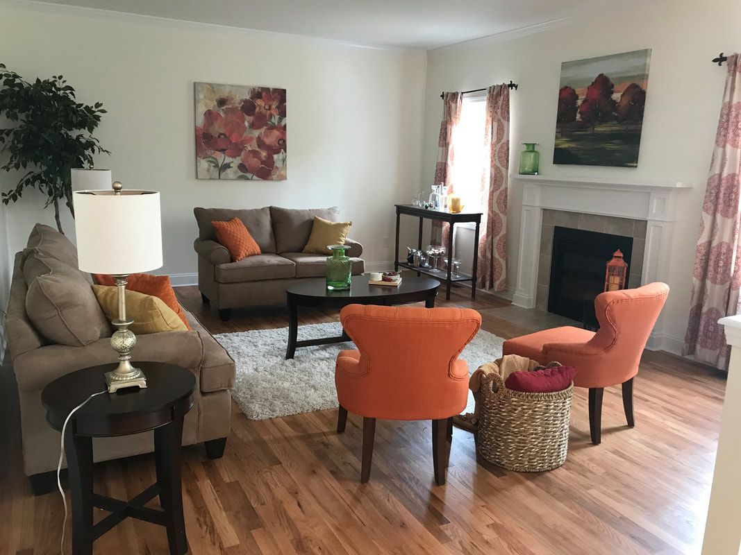 A living room filled with furniture and a fireplace.