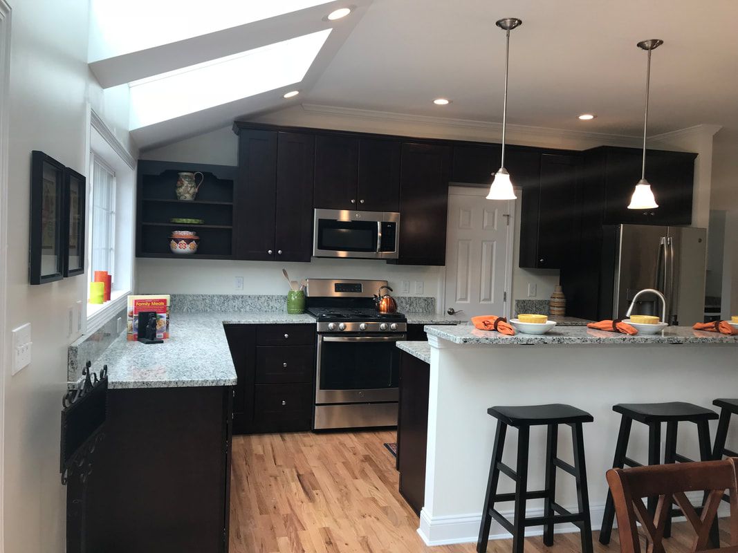 A kitchen with stools and a stove top oven