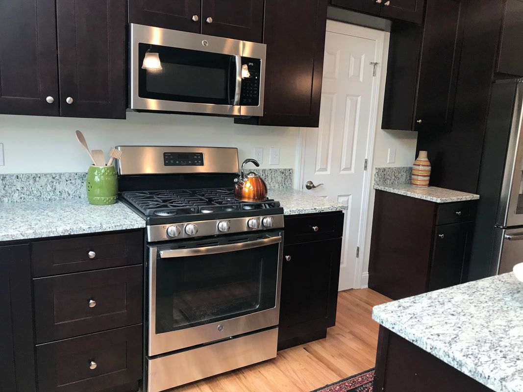 A kitchen with stainless steel appliances and granite counter tops