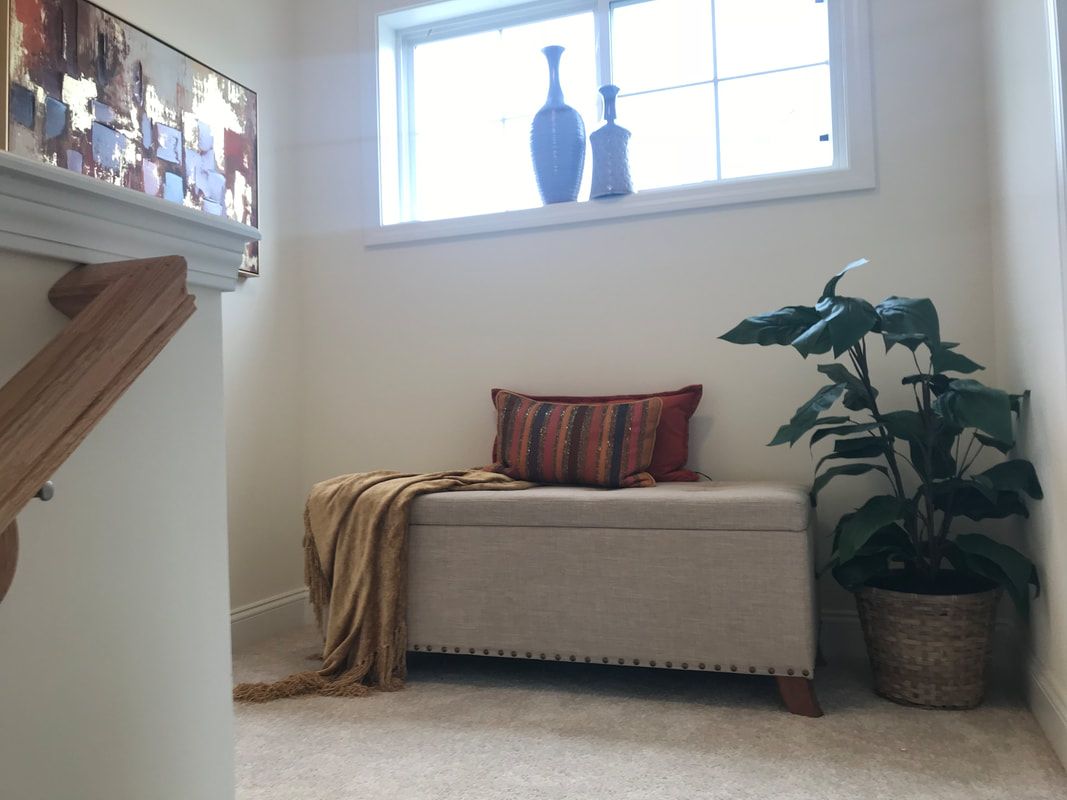 A staircase with a bench and a potted plant