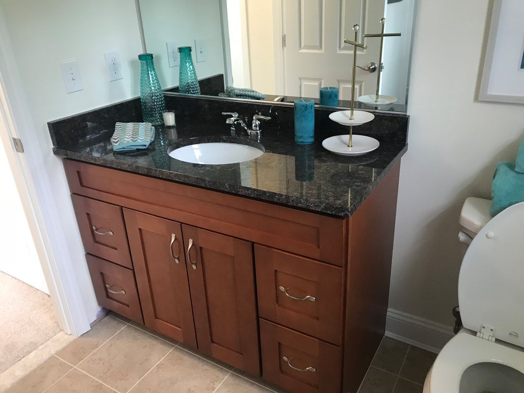 A bathroom with a sink , toilet and mirror.