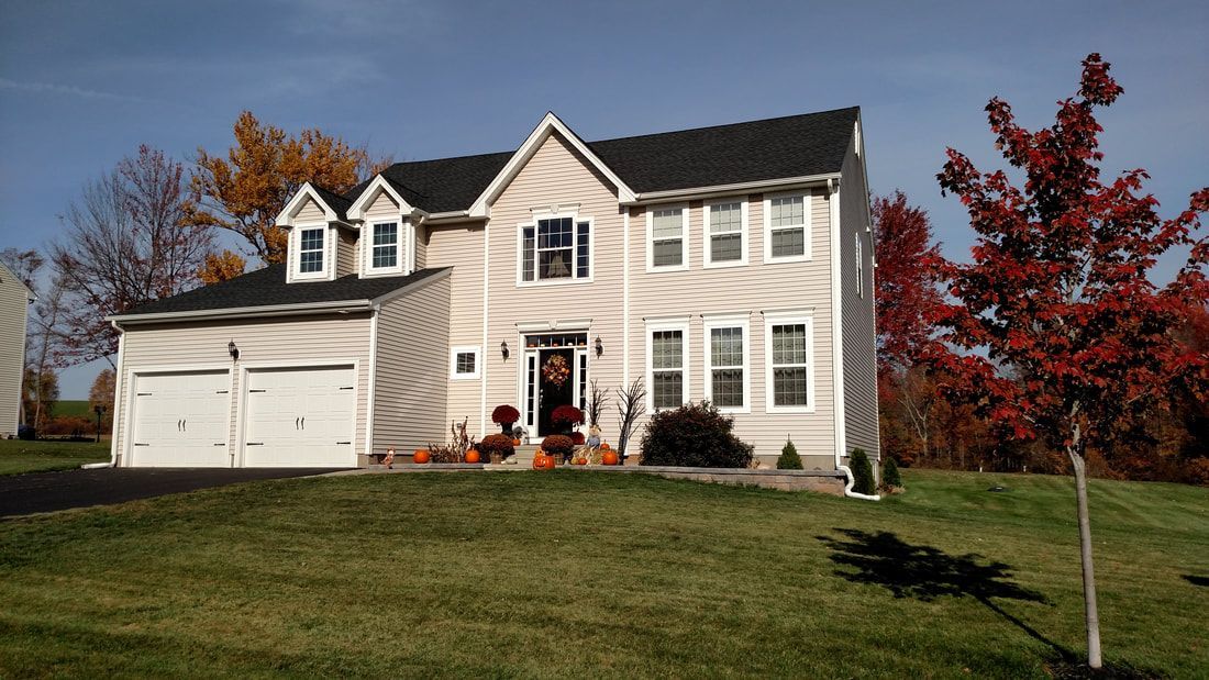 A large house with a tree in front of it