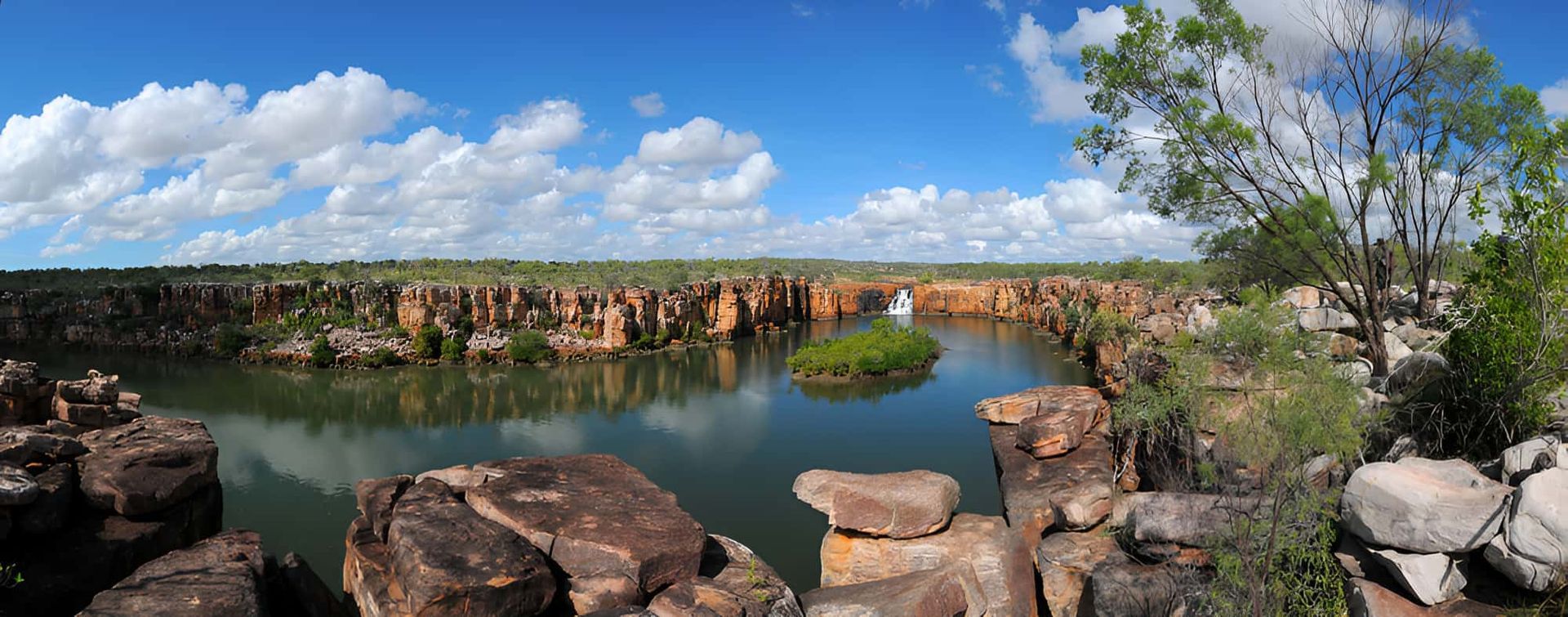 A Large Body of Water Surrounded by Rocks and Trees — John Day Plumbing in Casuarina, NT