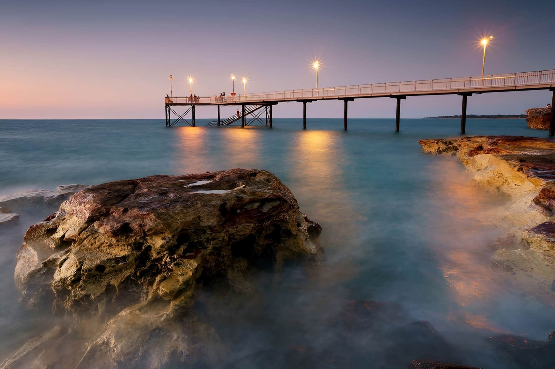 A Pier Overlooking a Body of Water With a Large Rock in the Foreground — John Day Plumbing in Nightcliff, NT