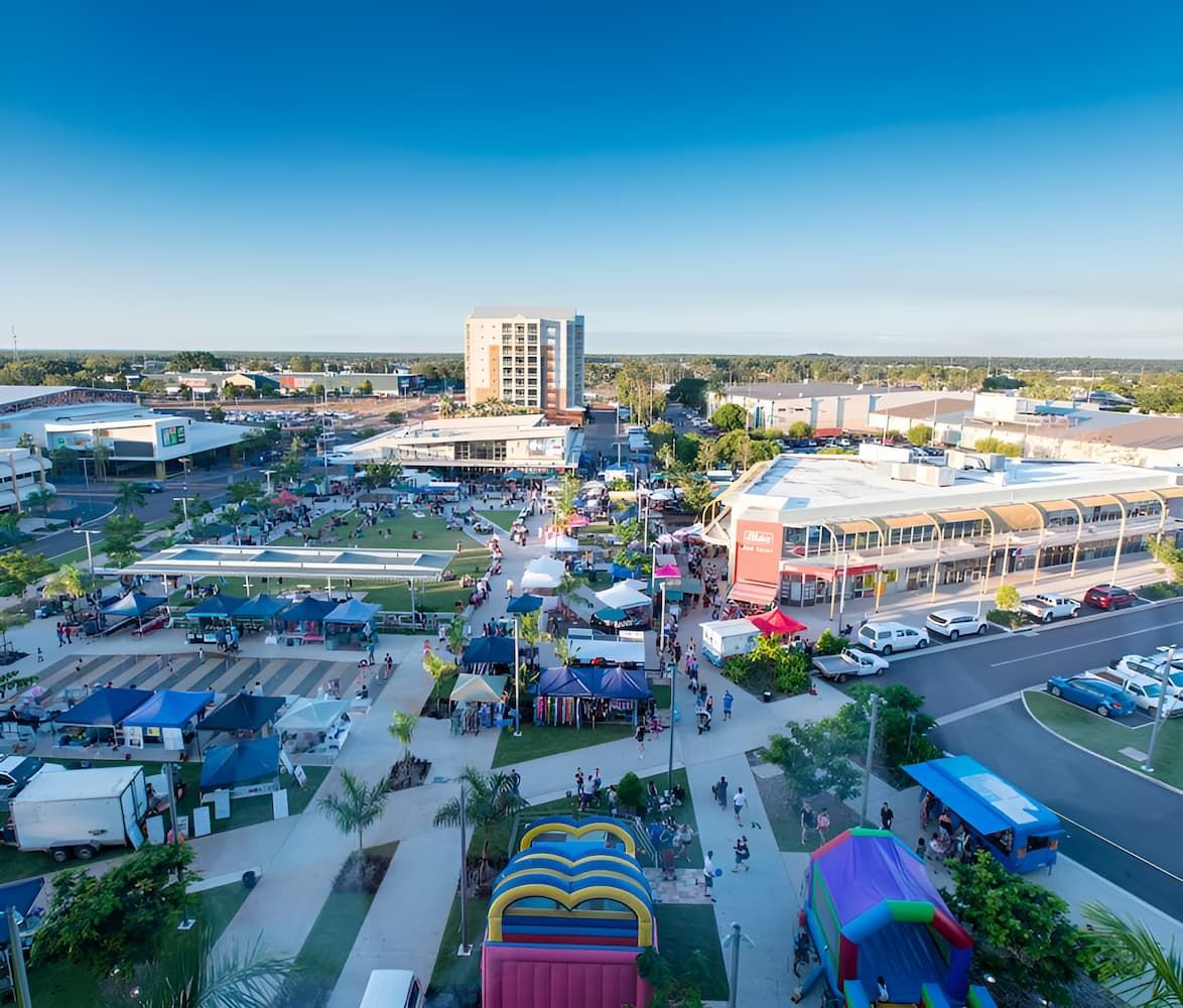 An Aerial View of a City With a Lot of People and Buildings — John Day Plumbing in Palmerston, NT
