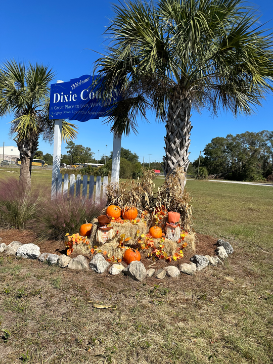 Restored building facade with proud community members in Dixie County, Florida
