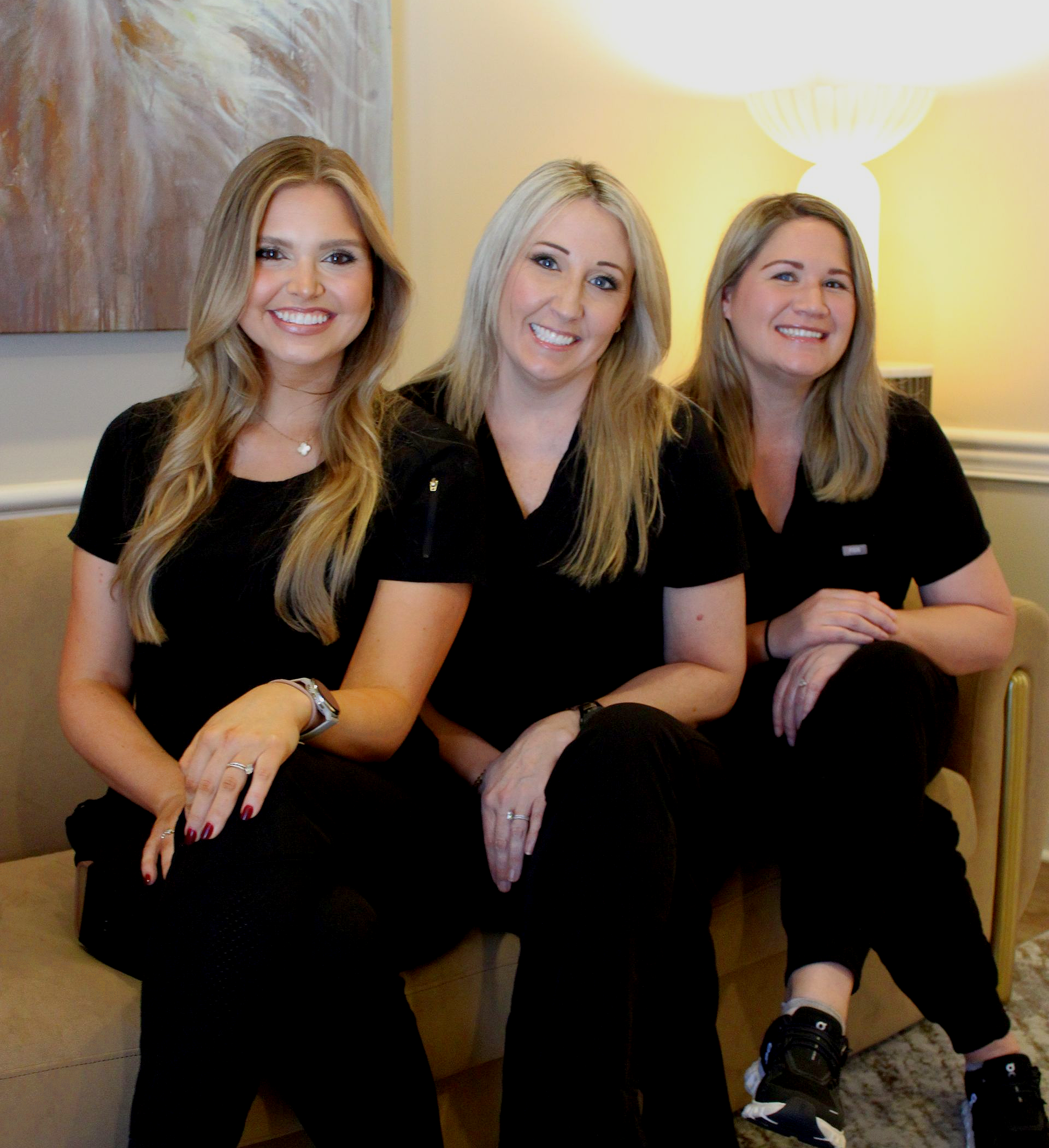 A dental assistant and dentist attending to a patient in a modern dental office.