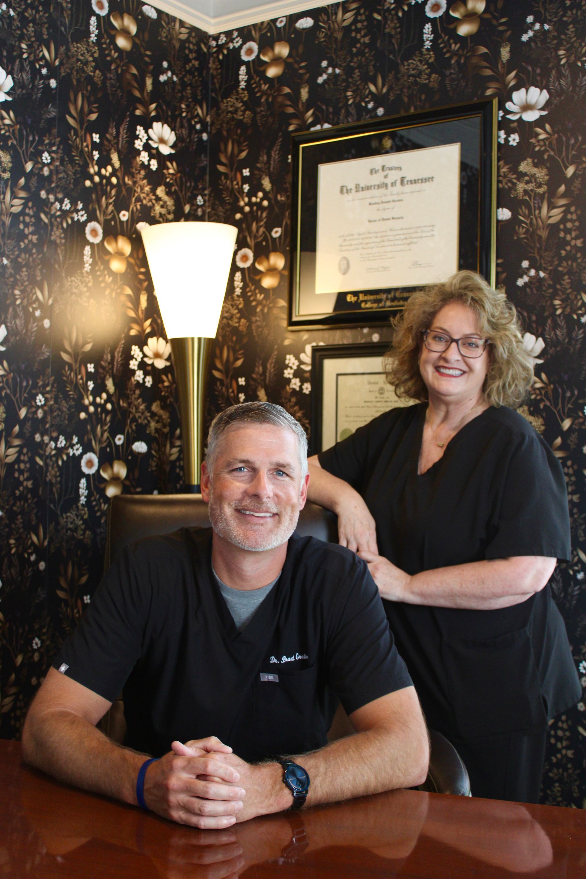 A dental assistant and dentist attending to a patient in a modern dental office.