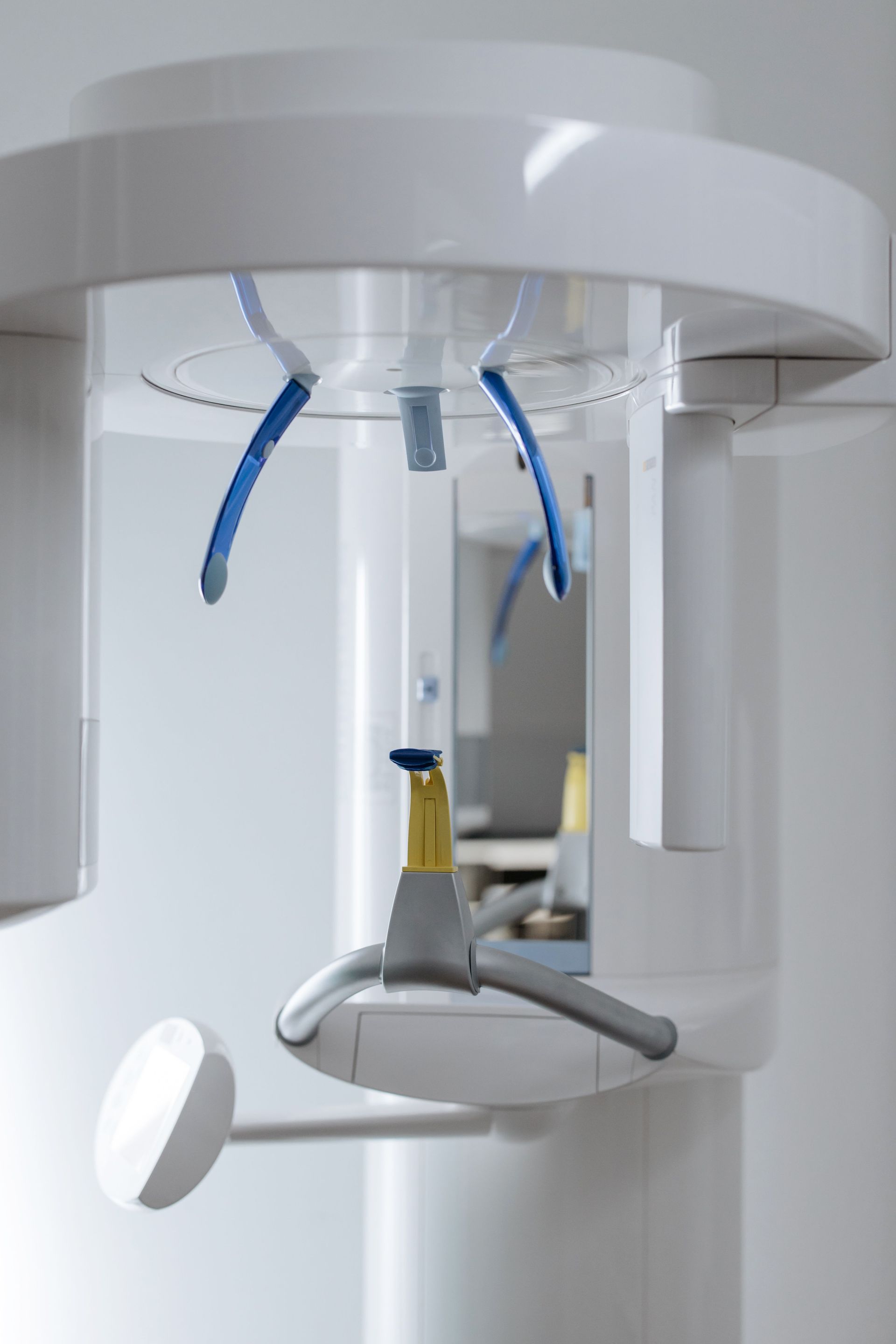 A dental assistant and dentist attending to a patient in a modern dental office.