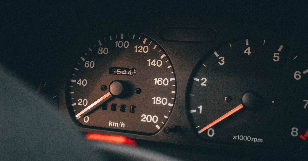Self-employed driver recording business miles in a mileage logbook