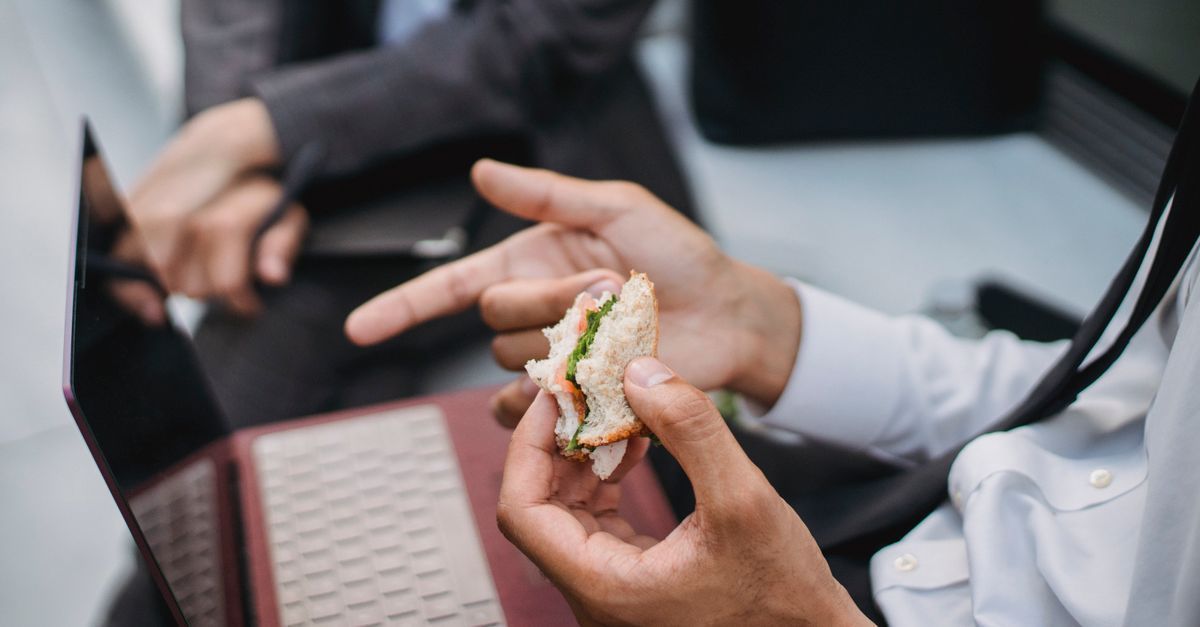 Small business owner discussing business with a client over lunch
