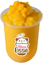 Orange mango smoothie in a clear cup topped with mango chunks and a bear logo label