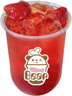 Red strawberry drink with ice and sliced strawberries in a clear cup labeled “Bear”