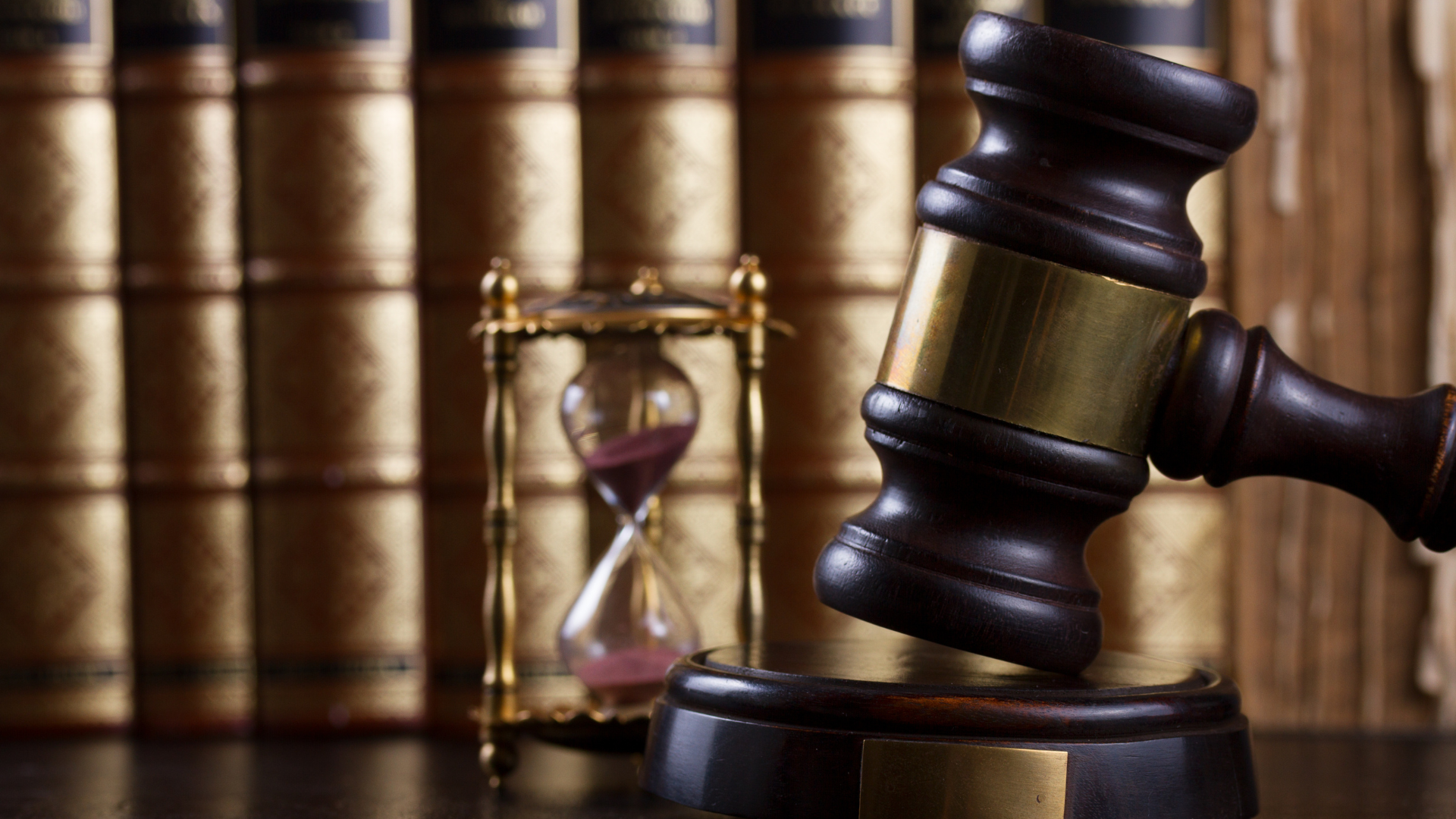 A man and a woman are looking at a tablet in an office.