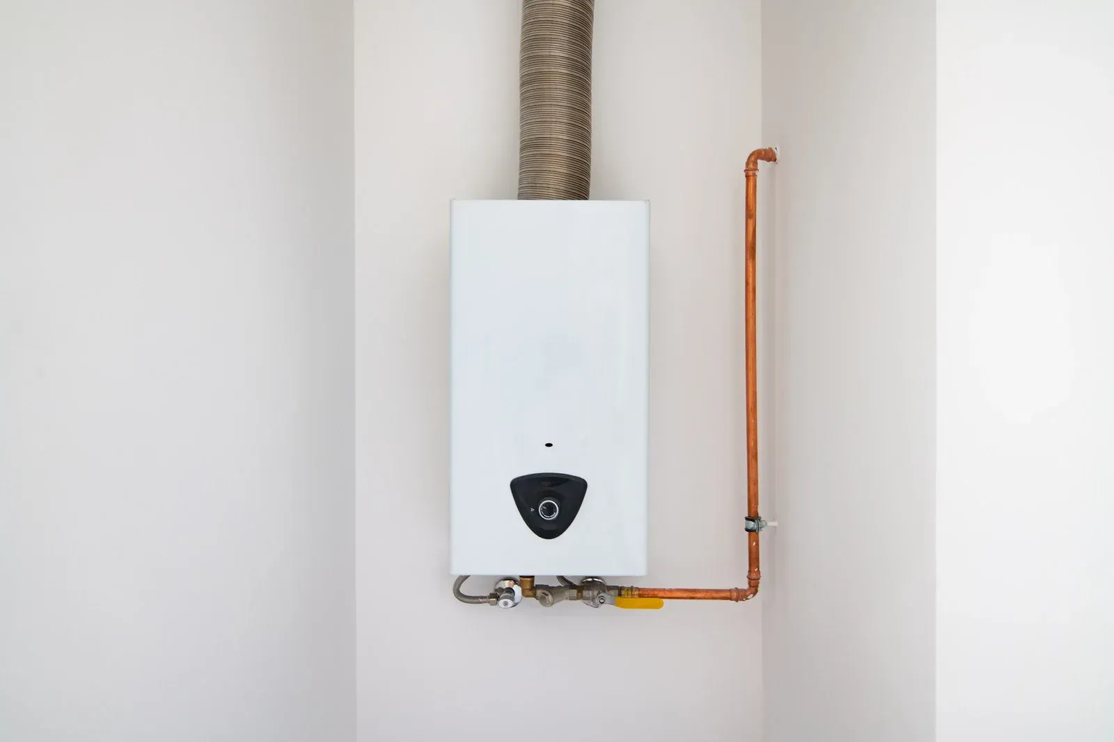 Open circuit breaker box on a beige wall; silver metal with black switches.