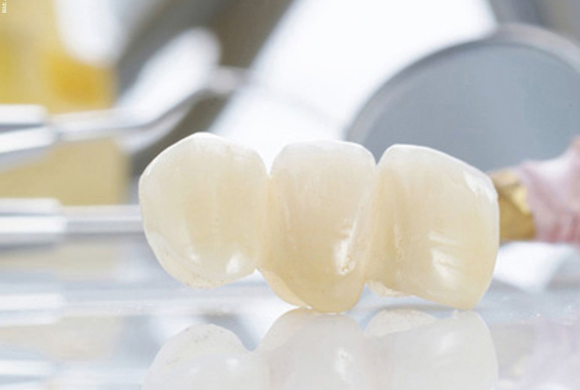 A close up of a dental bridge on a table.