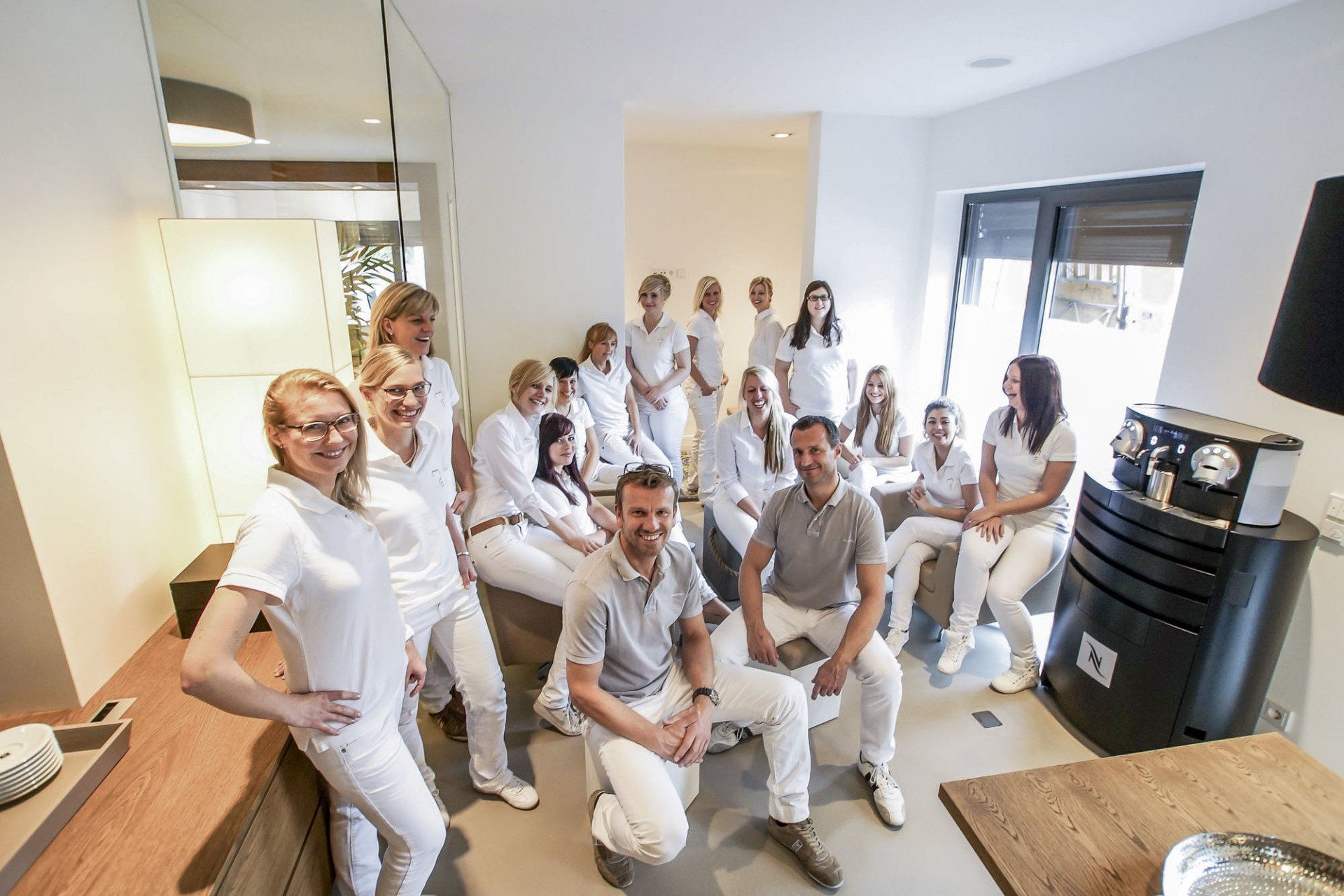 A group of people are posing for a picture in a room.