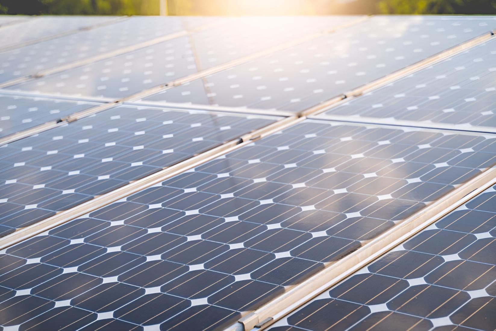 A Row of Solar Panels on a Roof With the Sun Shining Through Them — Power & Data Support Services In Manunda, QLD