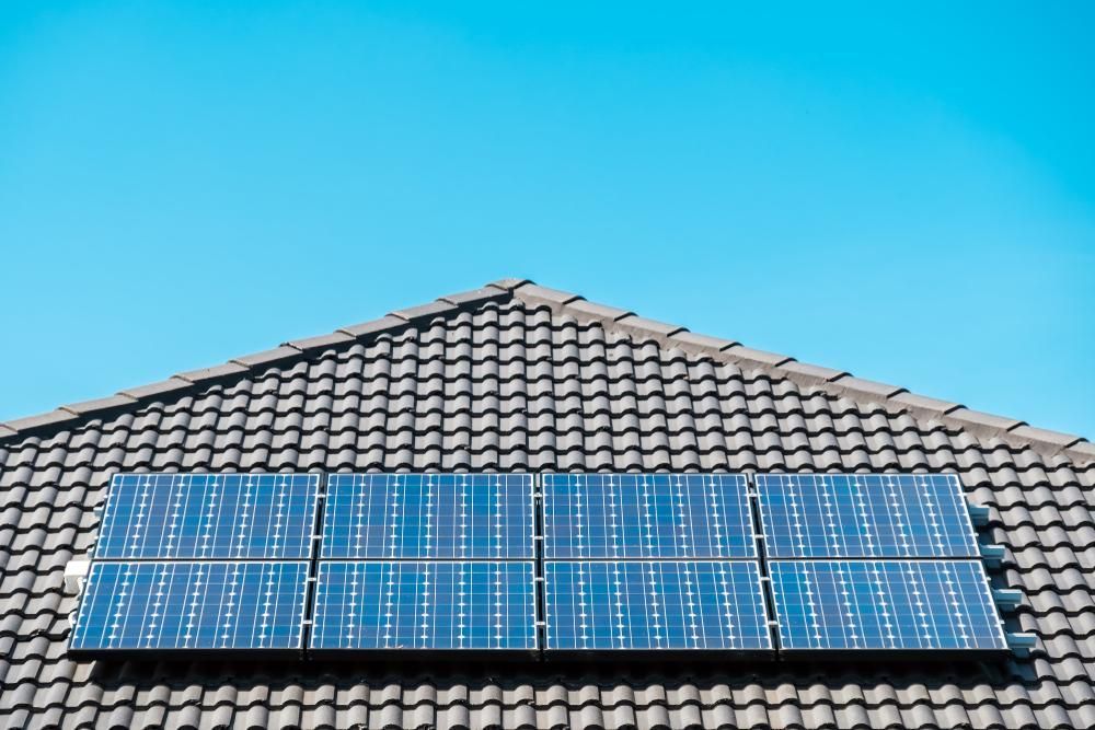 A Row of Solar Panels on the Roof of a House — Power & Data Support Services In Manunda, QLD