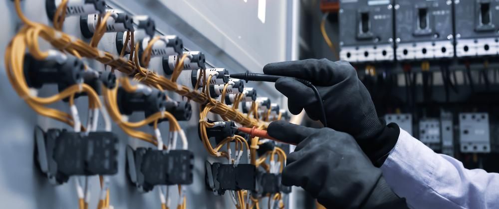 A Person is Working on an Electrical Panel With a Screwdriver — Power & Data Support Services In Charters Towers, QLD