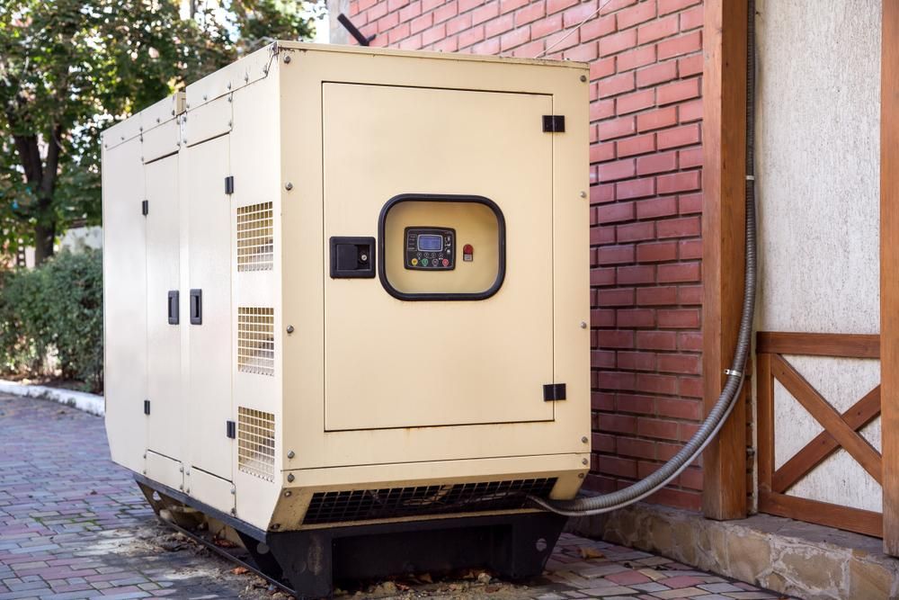 A Large Generator is Attached to the Side of a Brick Building — Power & Data Support Services In Charters Towers, QLD