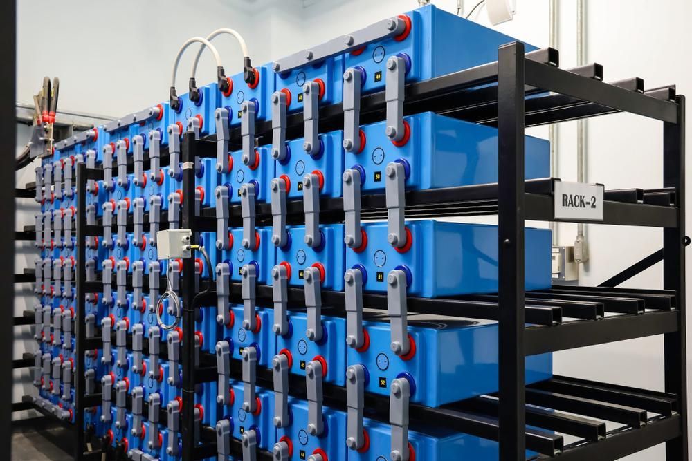 A Bunch of Blue Batteries Are Stacked on Top of Each Other on Shelves — Power & Data Support Services In Mt Isa, QLD