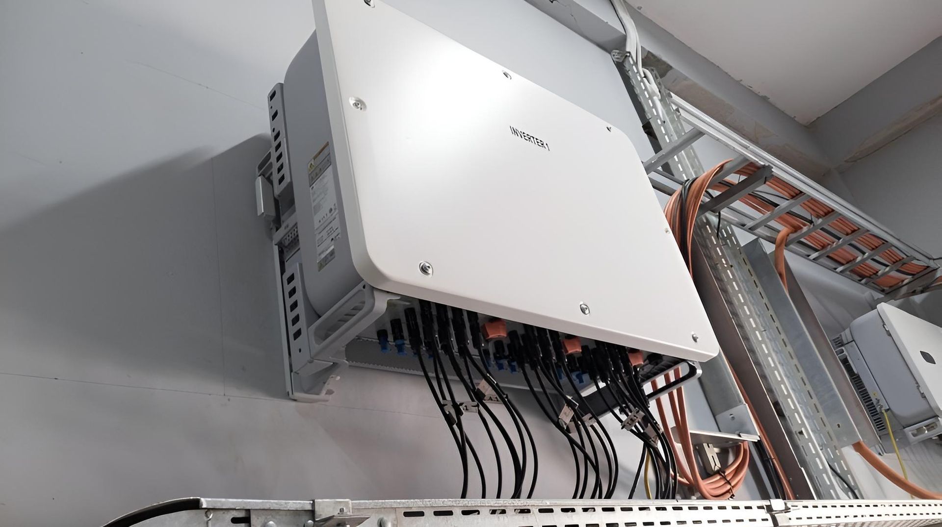 A White Box With a Lot of Wires Coming Out of It is Hanging on a Wall — Power & Data Support Services In Charters Towers, QLD