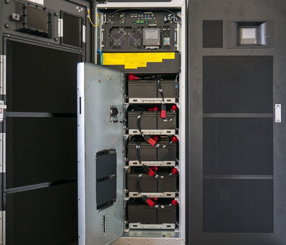 Battery in large uninterruptible Power Supply — Power & Data Support Services In Manunda, QLD