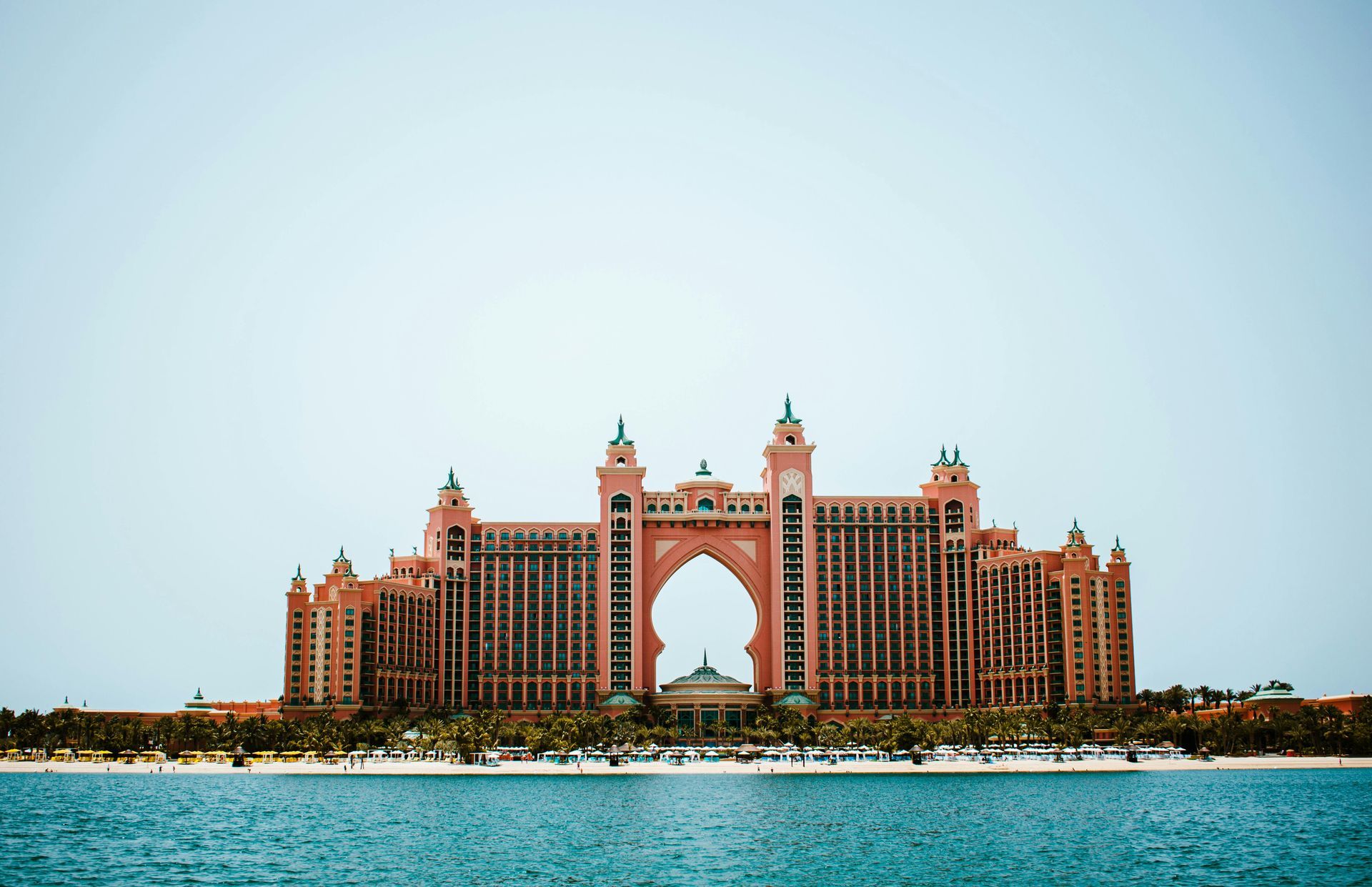 A large building is sitting on top of a body of water.