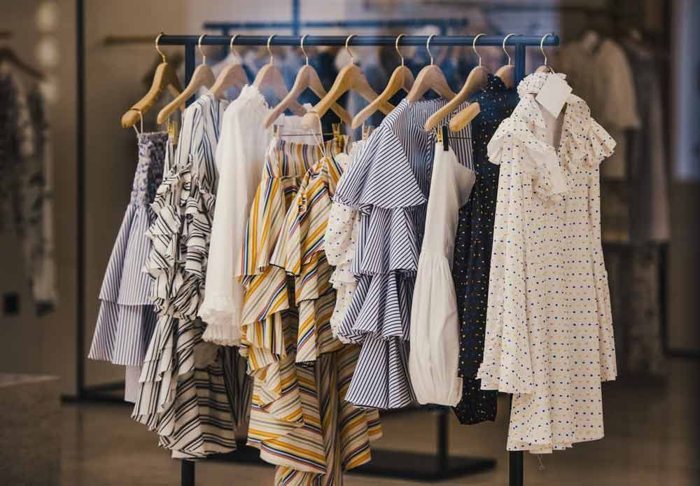 A Row Of Clothes Hanging On A Rack — Shop Fittings Office Furniture Materials Handling In Sydney, NSW