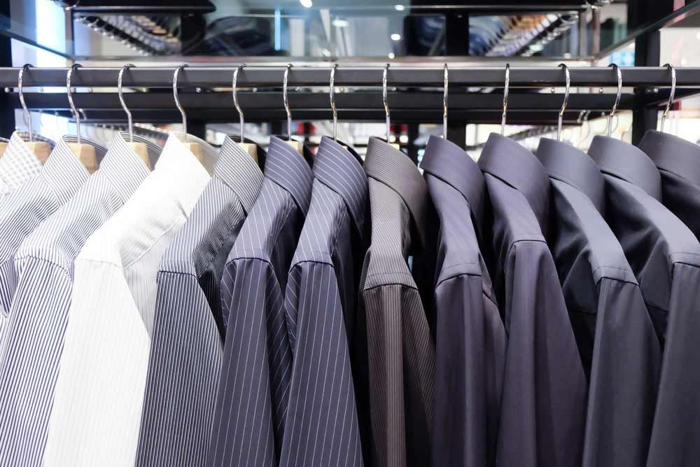 A Row Of Suits And Shirts On A Rack — Shop Fittings Office Furniture Materials Handling In Prestons, NSW