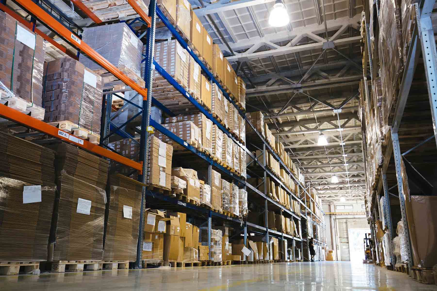 A Large Warehouse Filled Boxes On Shelves — Shop Fittings Office Furniture Materials Handling In Prestons, NSW