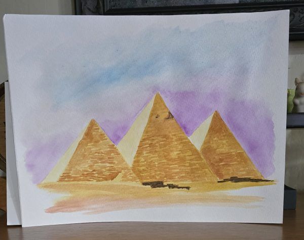 Three golden pyramids against a purple and blue watercolor sky on white paper.