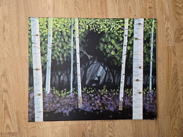 Birch trees in a forest with green leaves and purple flowers on the ground.