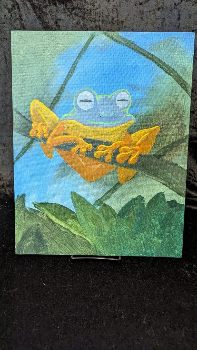 Yellow frog on a leaf against a blue-green background.