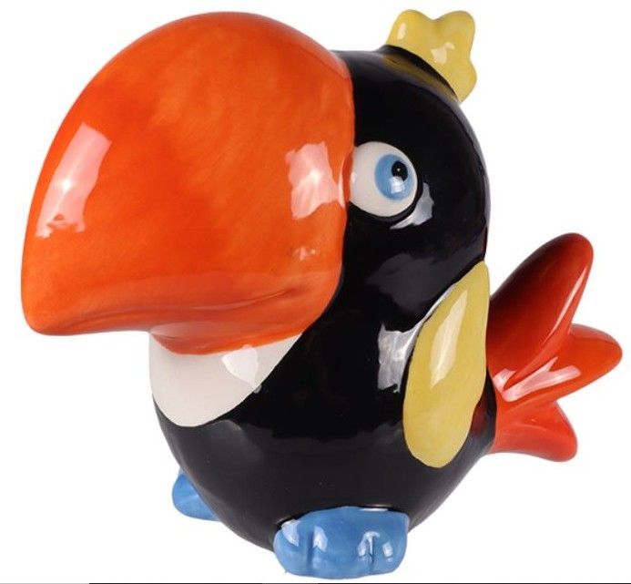 Colorful cartoon bird figurine with oversized orange beak, black body, and red tail feathers