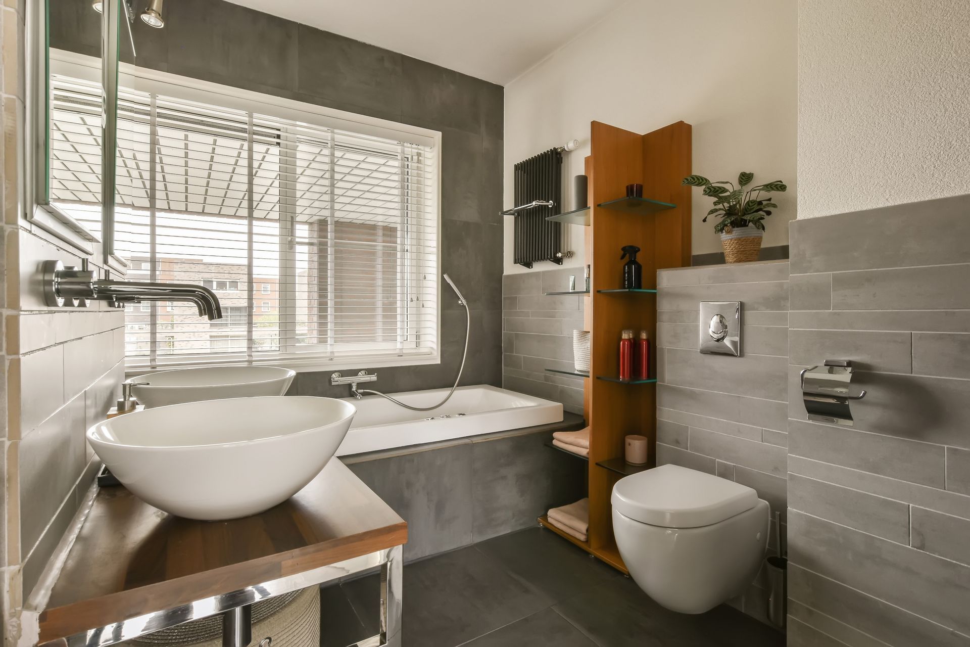 A bathroom with a sink , toilet , tub and window.