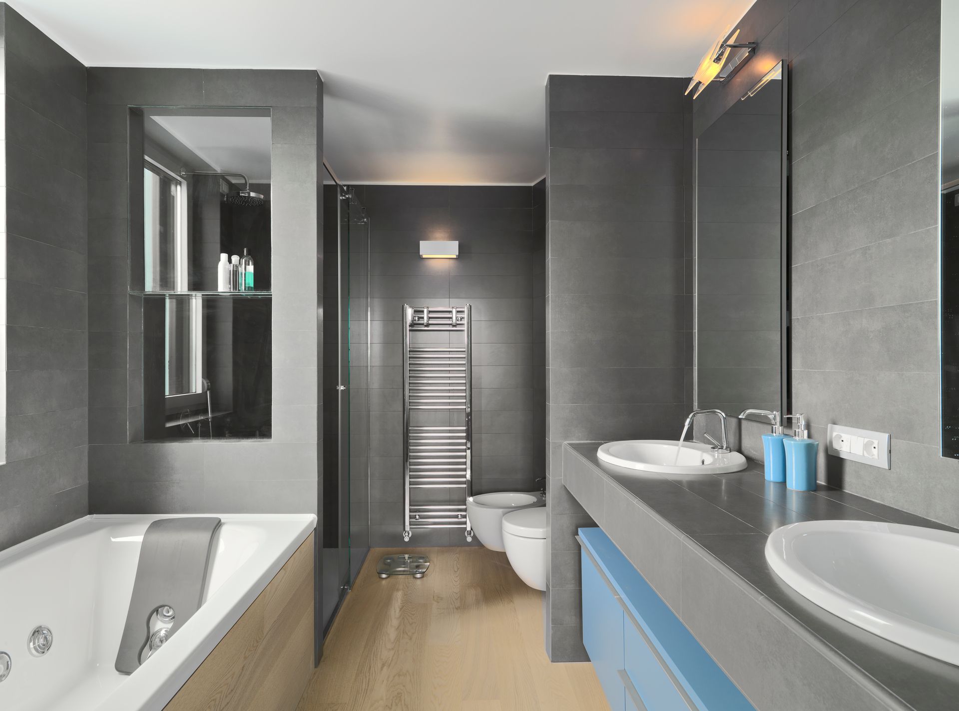A bathroom with a bathtub , sink , toilet and mirror.