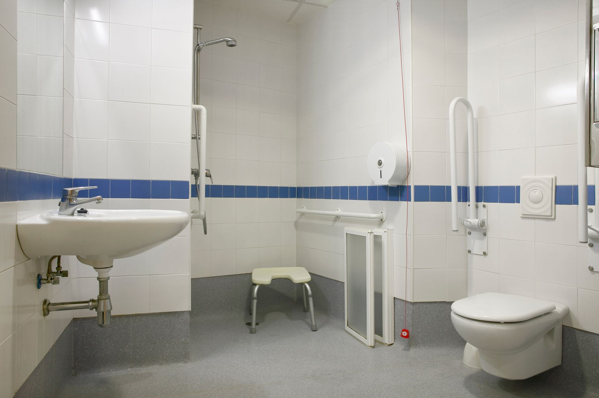 A bathroom with a sink , toilet and shower