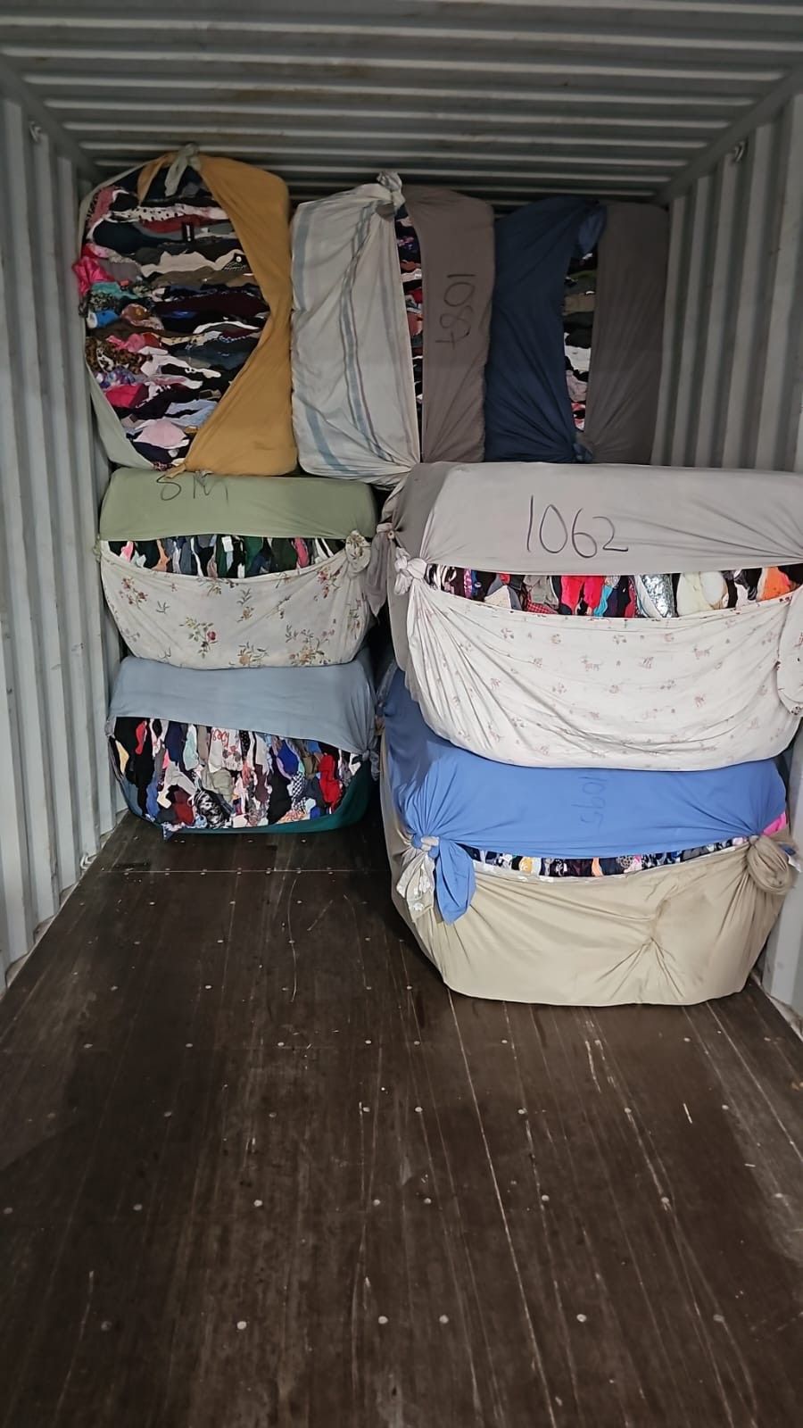 A container filled with lots of blankets and pillows.