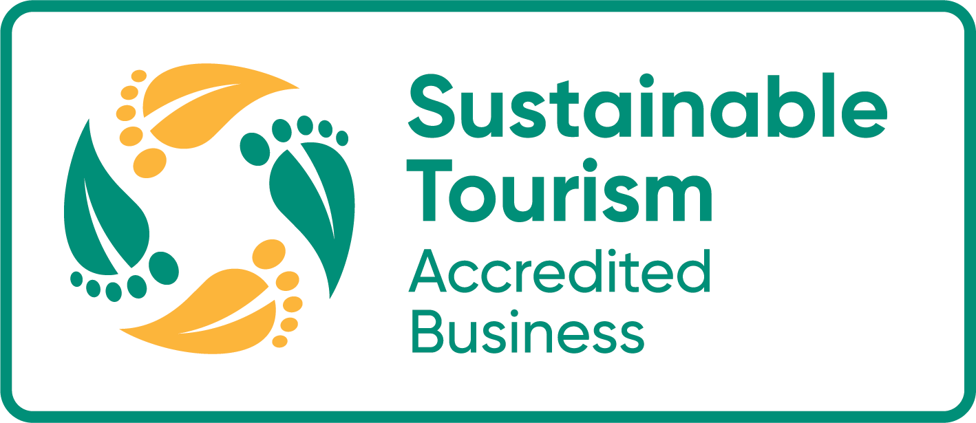 Sustainable Tourism Accredited Business logo with teal text and orange-green circular leaf emblem