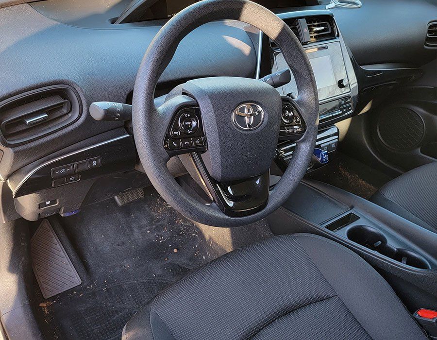 The interior of a toyota prius with a steering wheel